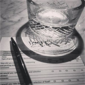 glass on top of a comment card in black and white